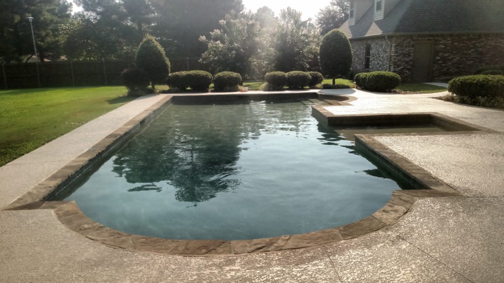 pool renovation with stamped and stained conrete sun pad and new plaster