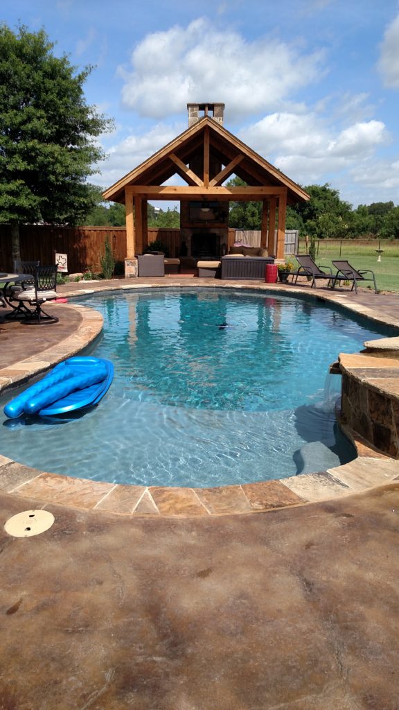 pool with outdoor kitchen under pergola